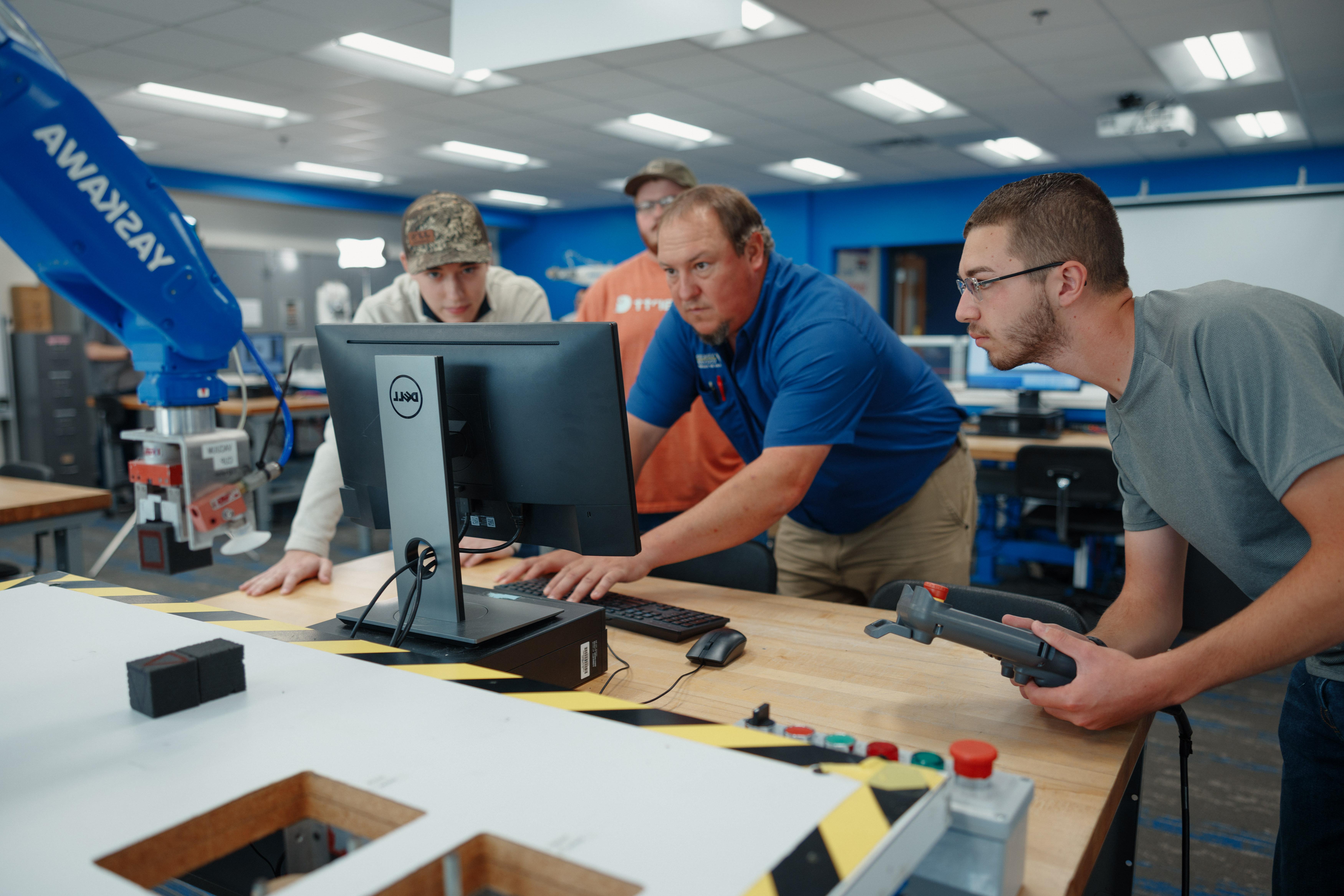 tech/manufacturing-technology-images/students-watch-a-professor-as-he-does-work-on-the-computer